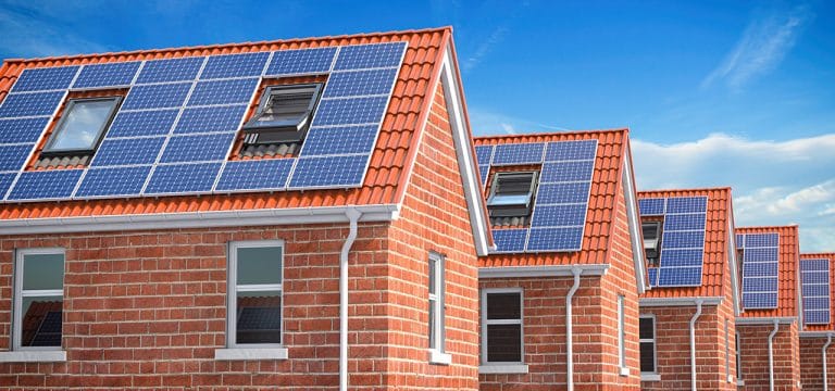 Row of house with solar panels on roof  on blue sky background